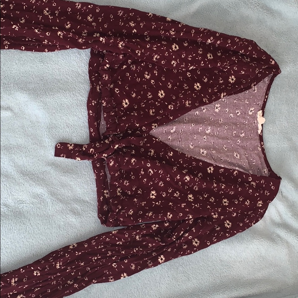 A long sleeve burgundy shirt w flowers.